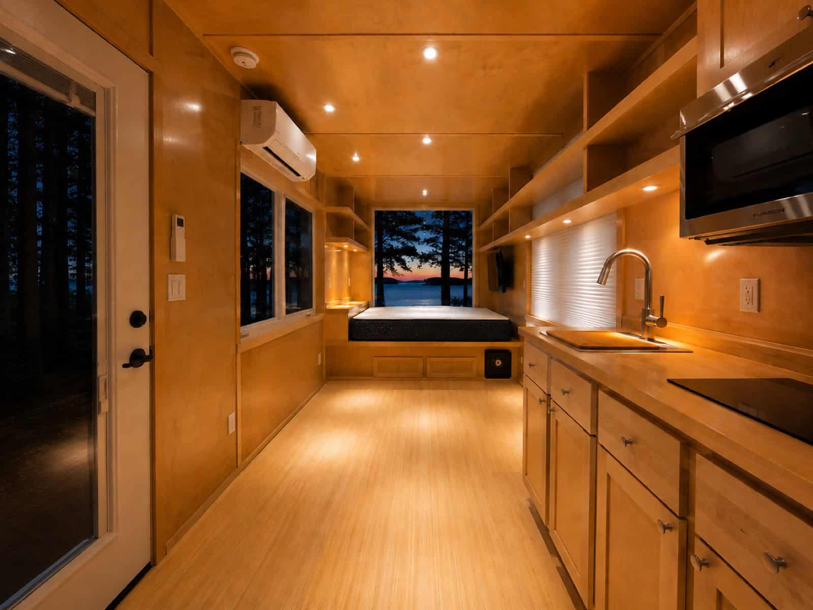 Interior of the Escape eVista looking from the entry door toward the built-in bed and window wall