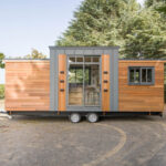 Eucalyptus tiny house with all one level, modern design, and large windows for natural light.