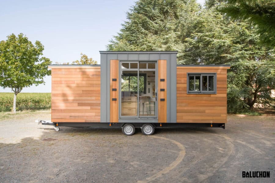Eucalyptus tiny house with all one level, modern design, and large windows for natural light.