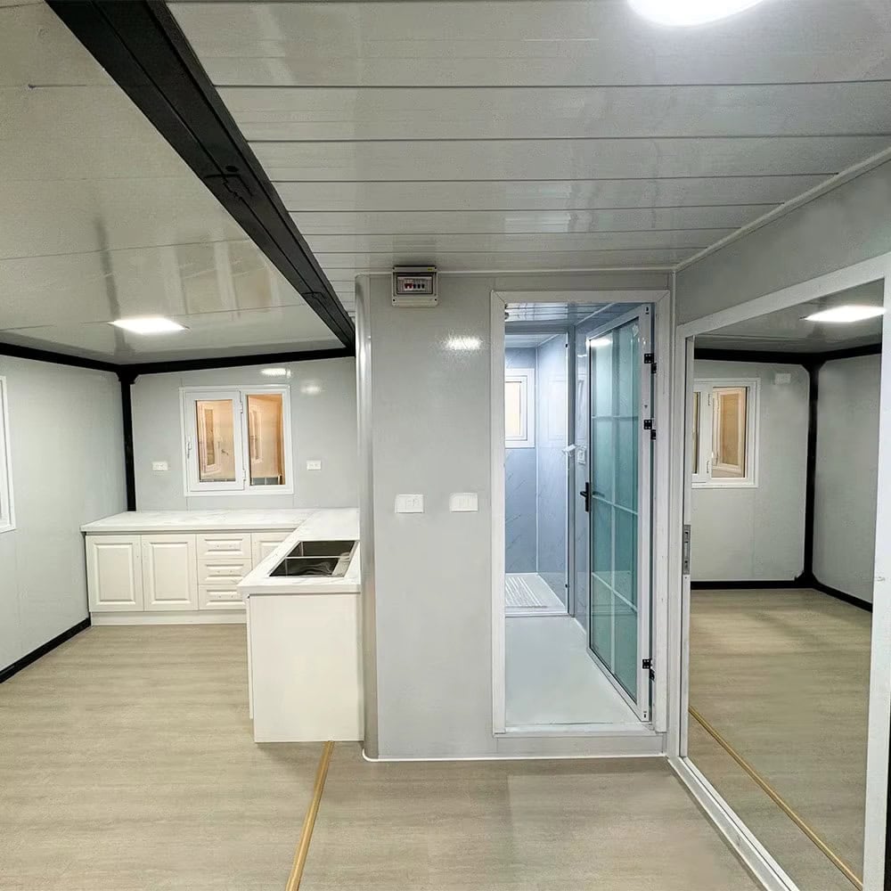 Interior view showing kitchen counter bathroom glass door and hallway to bedrooms