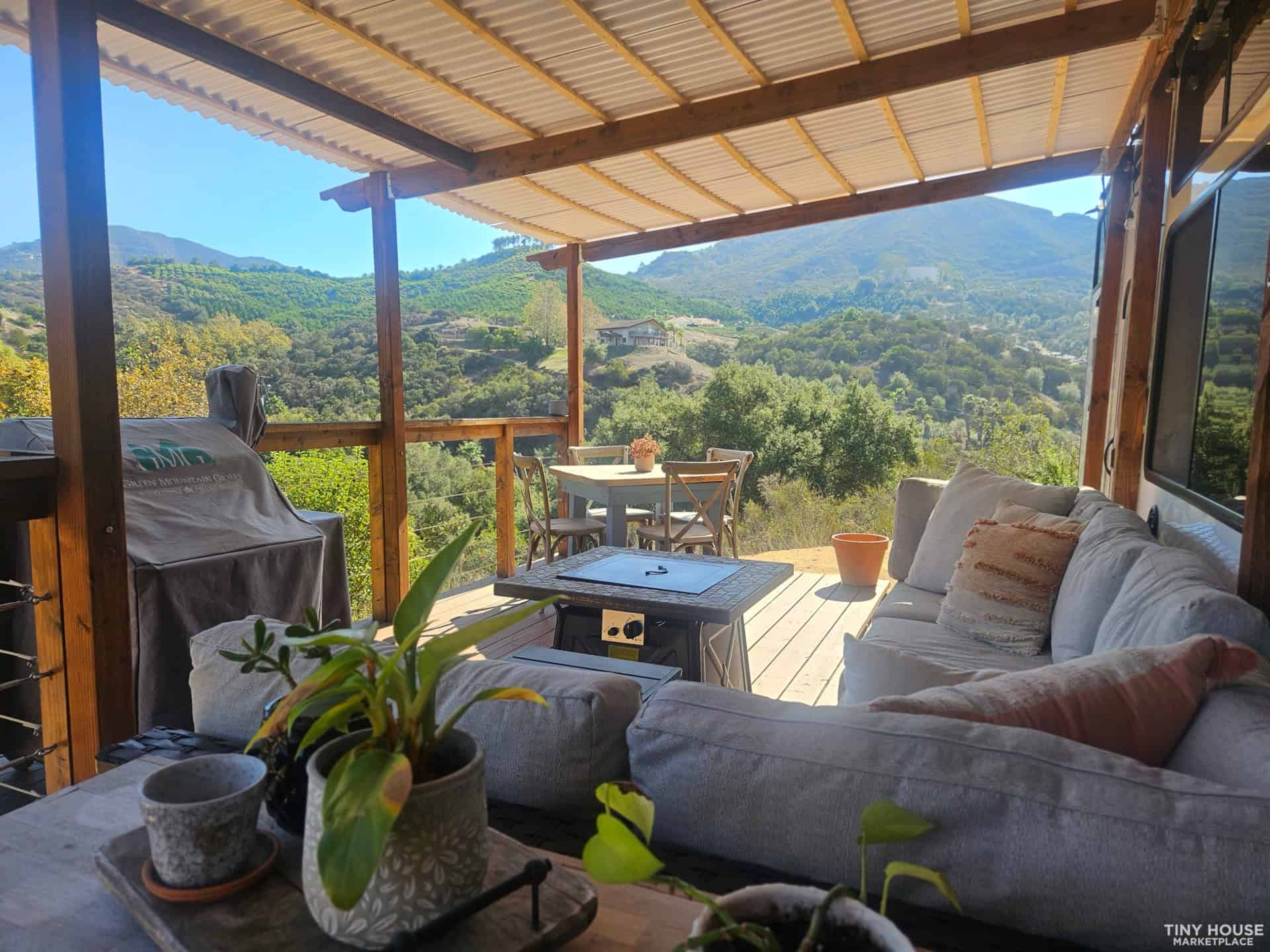 Outdoor living space with comfortable seating and lush mountain scenery.
