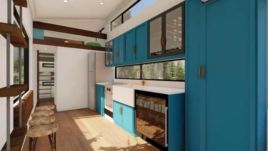 Modern tiny home interior with vibrant blue cabinetry and cozy kitchen space.