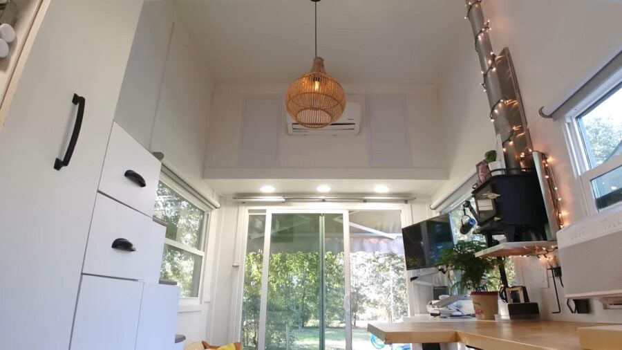 Cozy tiny house interior with family of three, bright windows, and modern decor for small space livi.