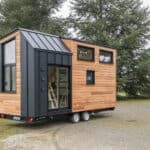 Tiny house with two-bedroom loft, perfect for small families seeking compact living solutions.
