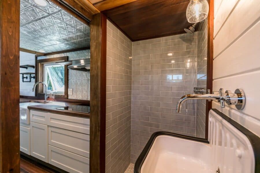 Compact lofted farmhouse bathroom with modern fixtures and cozy design.