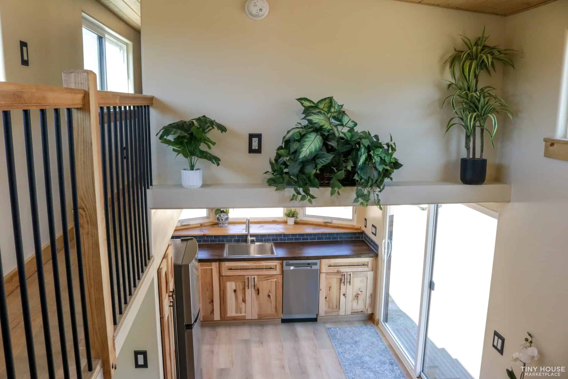 View down from the upstairs walkway over the kitchen and sliding glass door