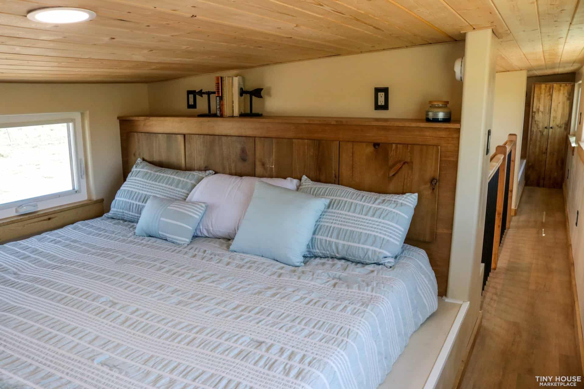 Upstairs bedroom with king-size bed and wood plank ceiling