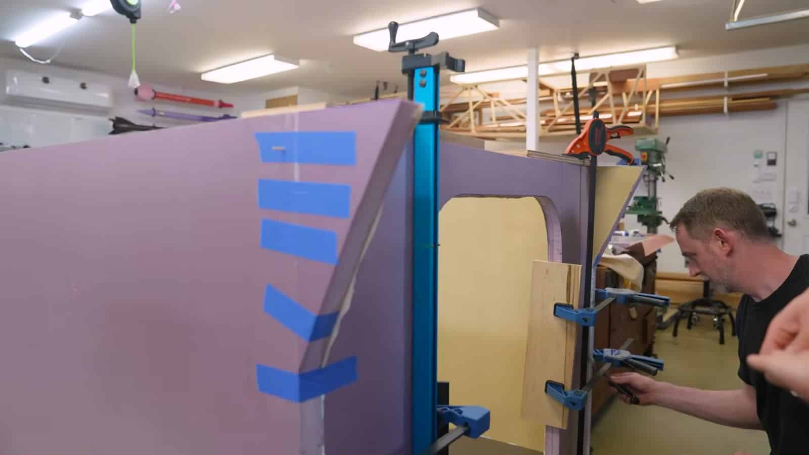 Foam camper shell clamped together while the foamboard adhesive cures
