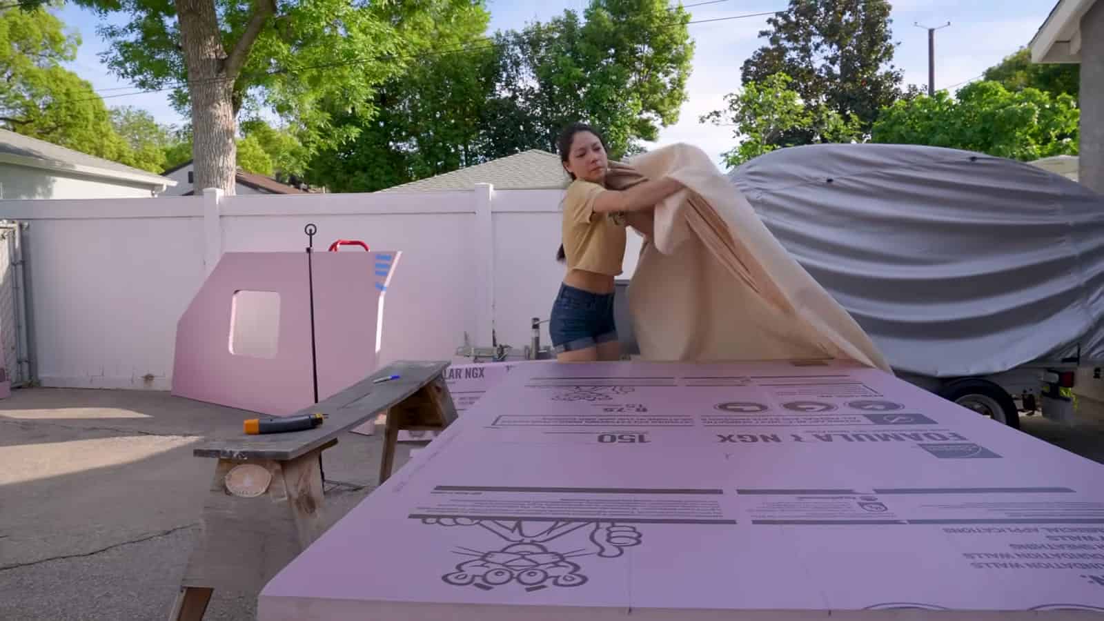 Laying cotton duck canvas over a pink foam wall panel
