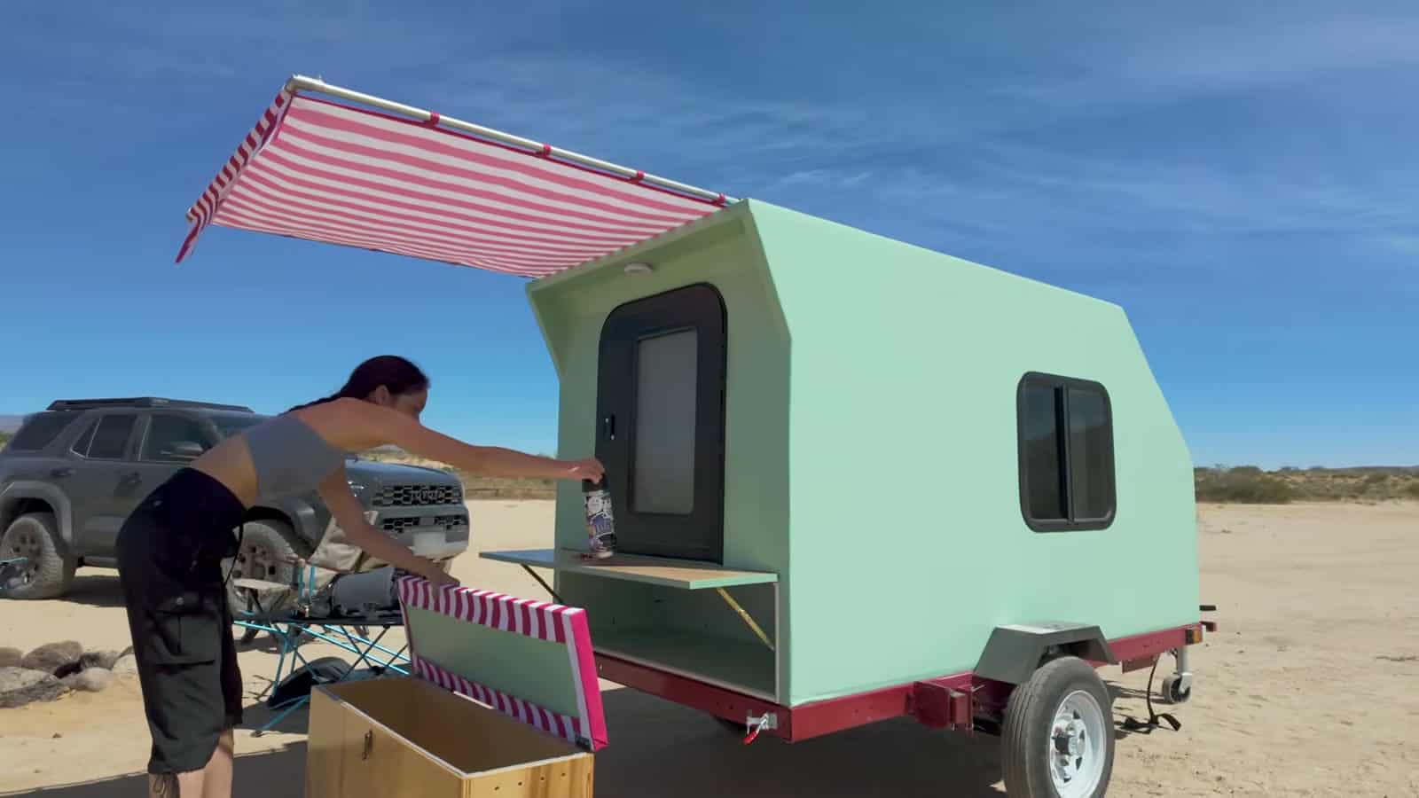Sliding conduit awning with scalloped red and white striped canvas
