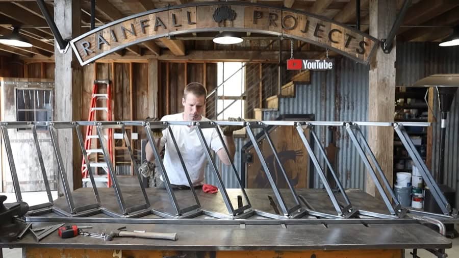 Custom space-saving folding stairs in a tiny house workshop.