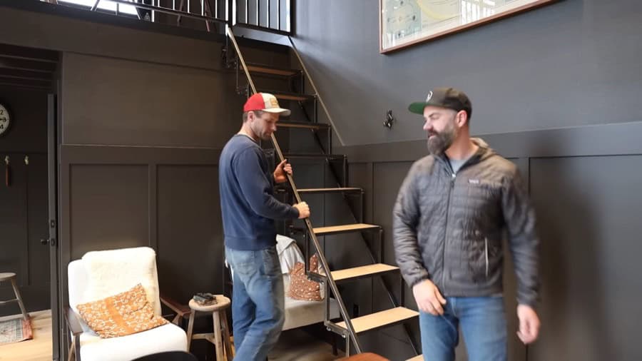 Innovative space-saving folding stairs in a tiny house interior.