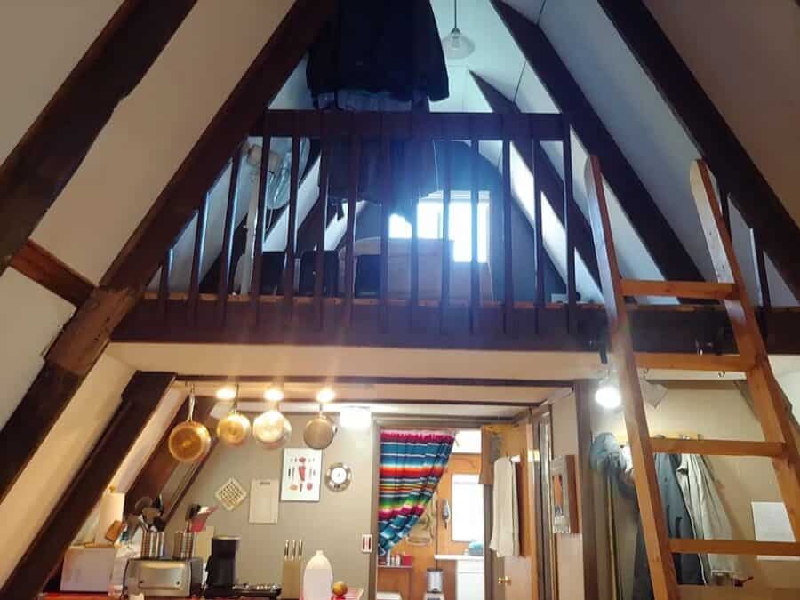 A-frame tiny house interior with loft bedroom and rustic decor in Fort Davis, Texas.