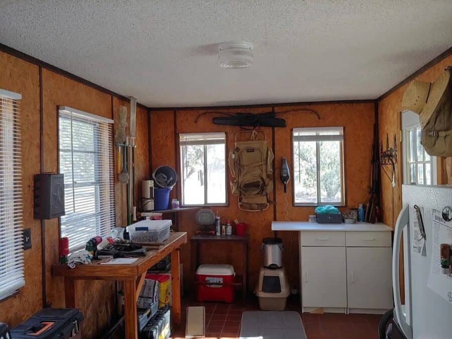 Compact tiny house interior with wood paneling and natural light.