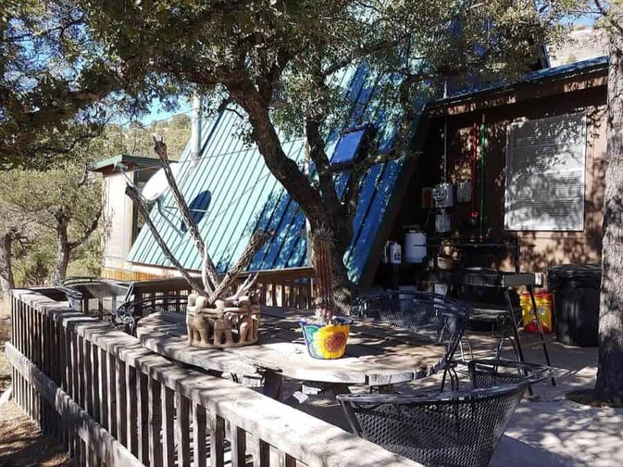 Cozy A-frame cabin with outdoor deck and seating in Fort Davis, Texas.