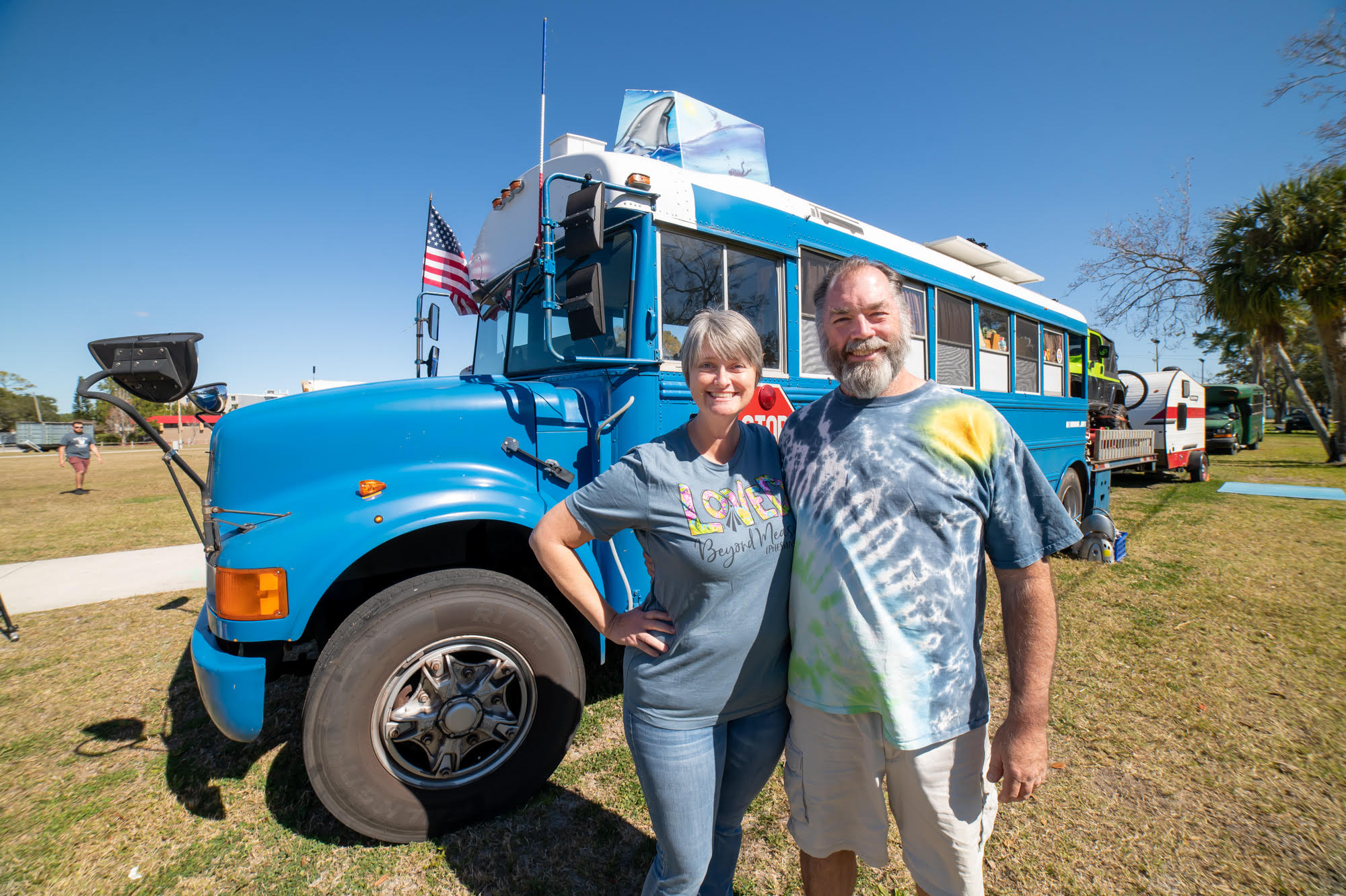 Founders of Skoolie Swarm and their Big Blue Hauler 2