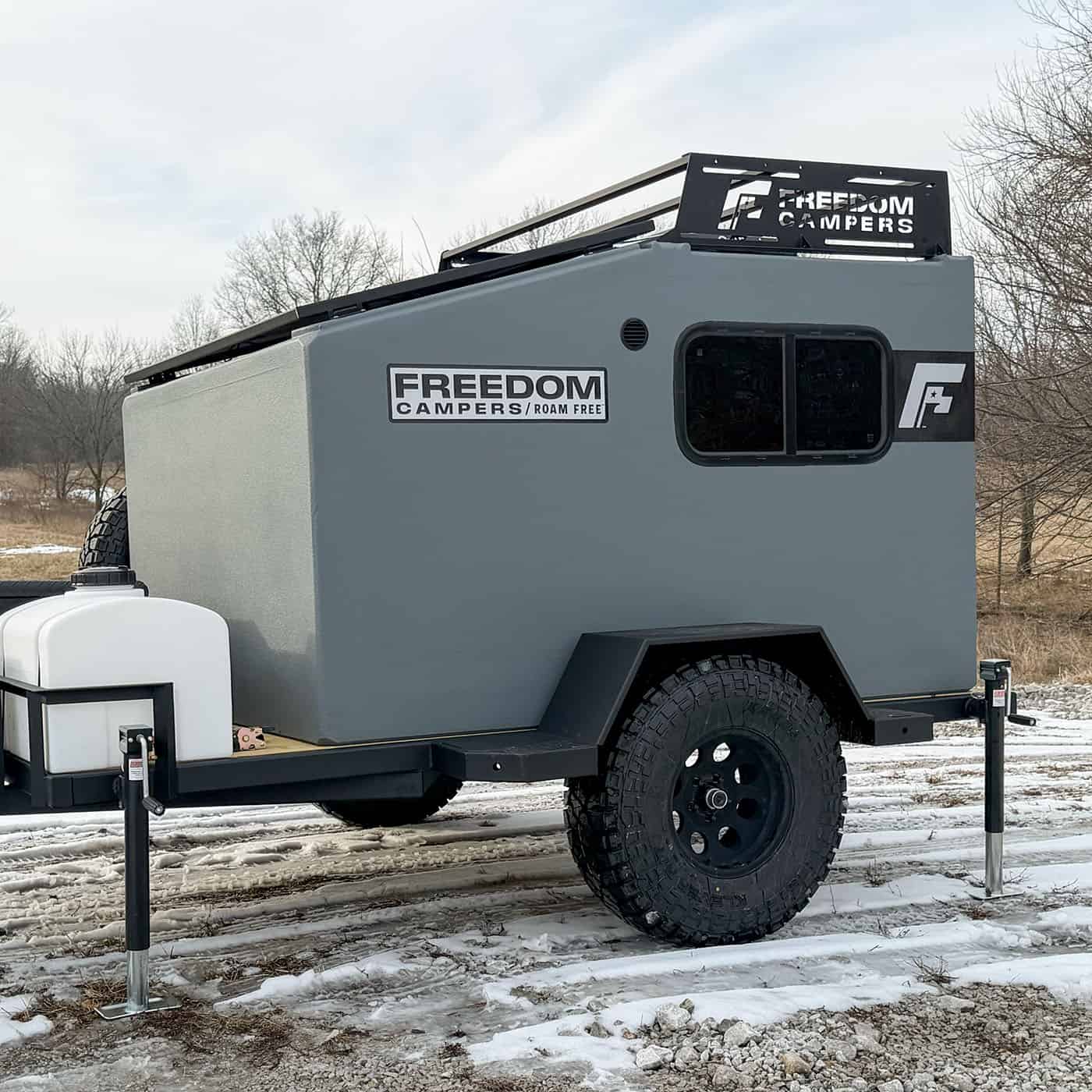 72 x 89 Freedom Camper on an off-road trailer with a roof rack and water tank