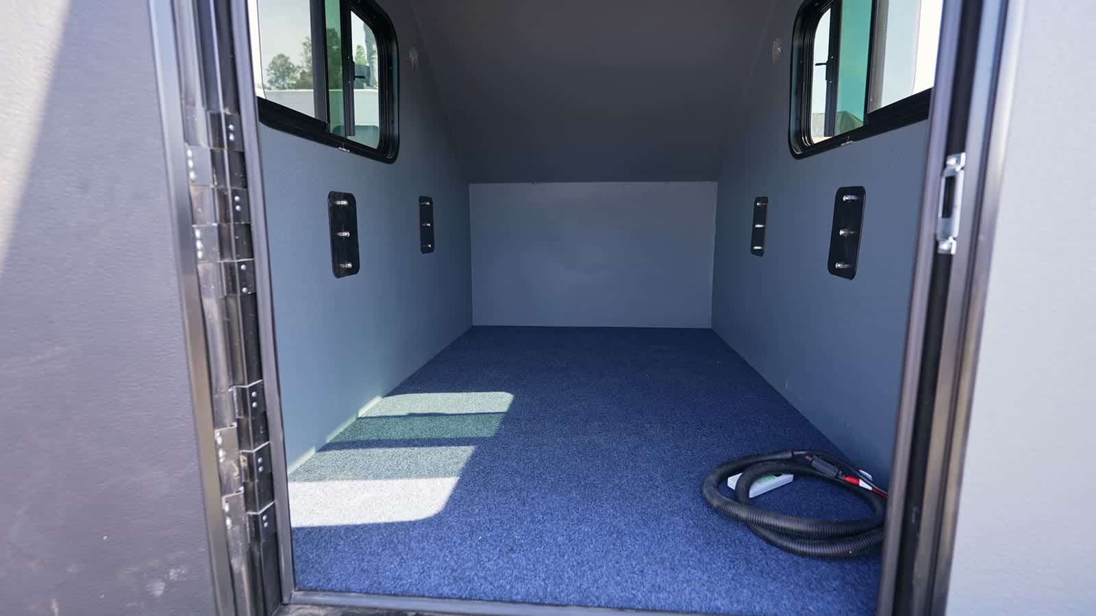 Empty interior of a Freedom Camper with carpeted floor