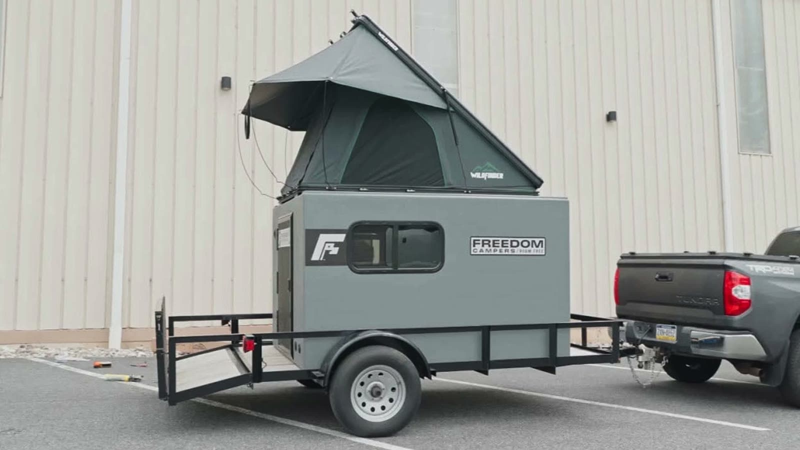 Freedom Camper with a rooftop tent on a small utility trailer