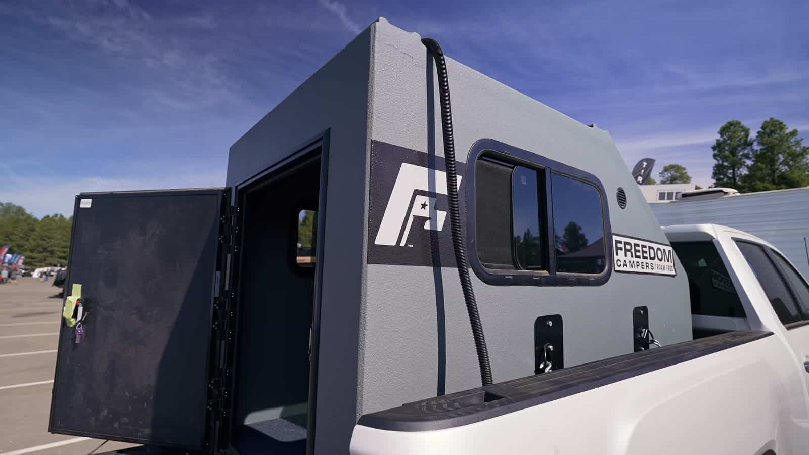 Freedom Camper mounted in a pickup bed with the side door open