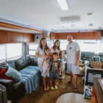 Family enjoying time together inside a cozy RV home.