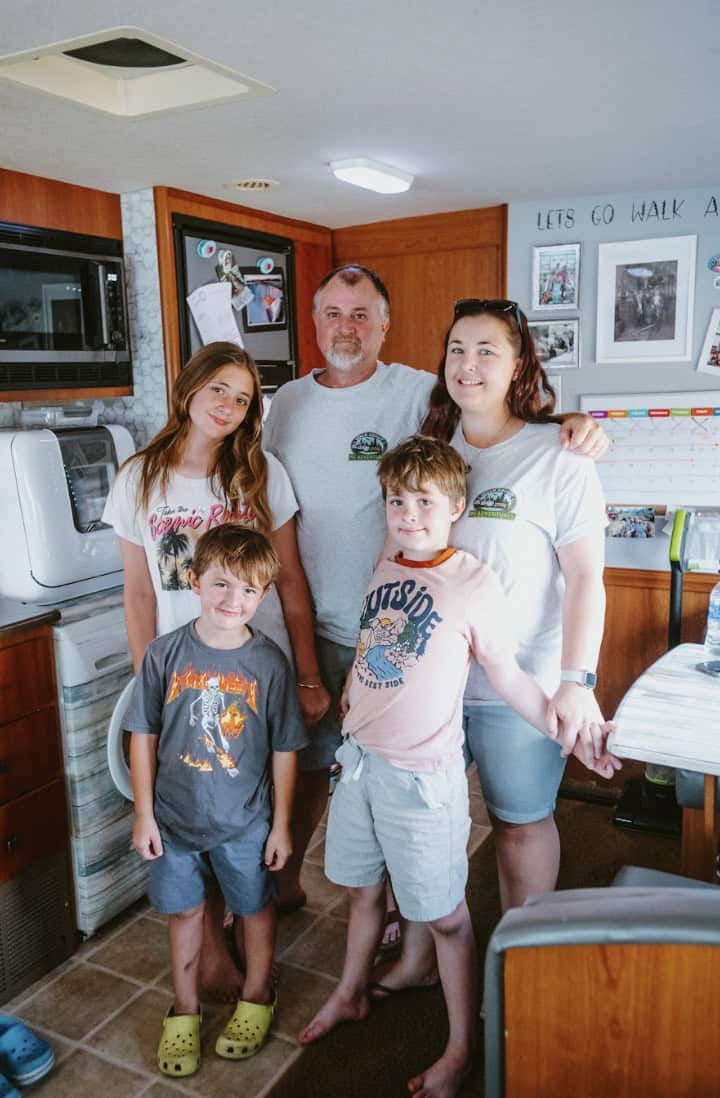 Family in a small kitchen celebrating their move from a large home to RV living.