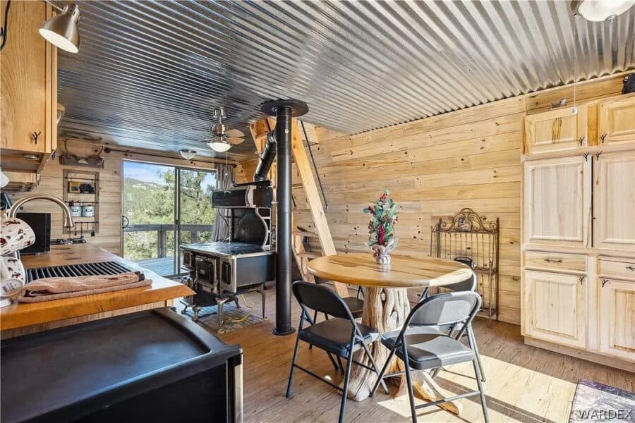 Interior of a rustic Arizona cabin with mountain views, wooden walls, and cozy furnishings.