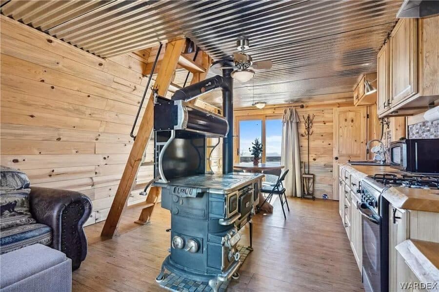 Charming tiny cabin interior featuring wood accents and a vintage stove, perfect for small space liv.