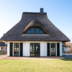 Charming 387 sq. ft. German cottage guesthouse with a thatched roof, perfect for small space living.
