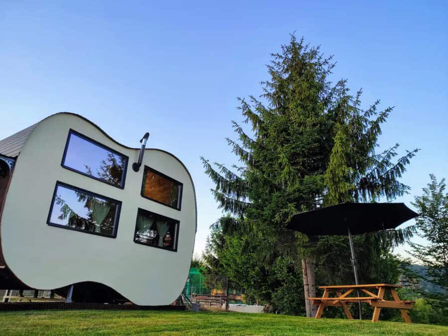 Funky guitar-shaped tiny house in Romania surrounded by nature and mountain views. Perfect for small.
