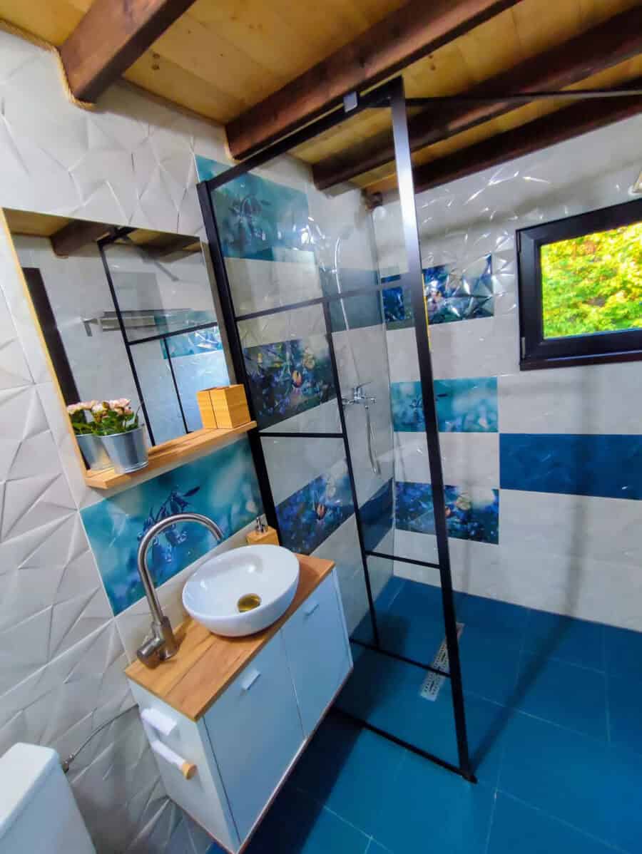Bathroom in Funky Guitar Tiny House Romania with scenic mountain views.