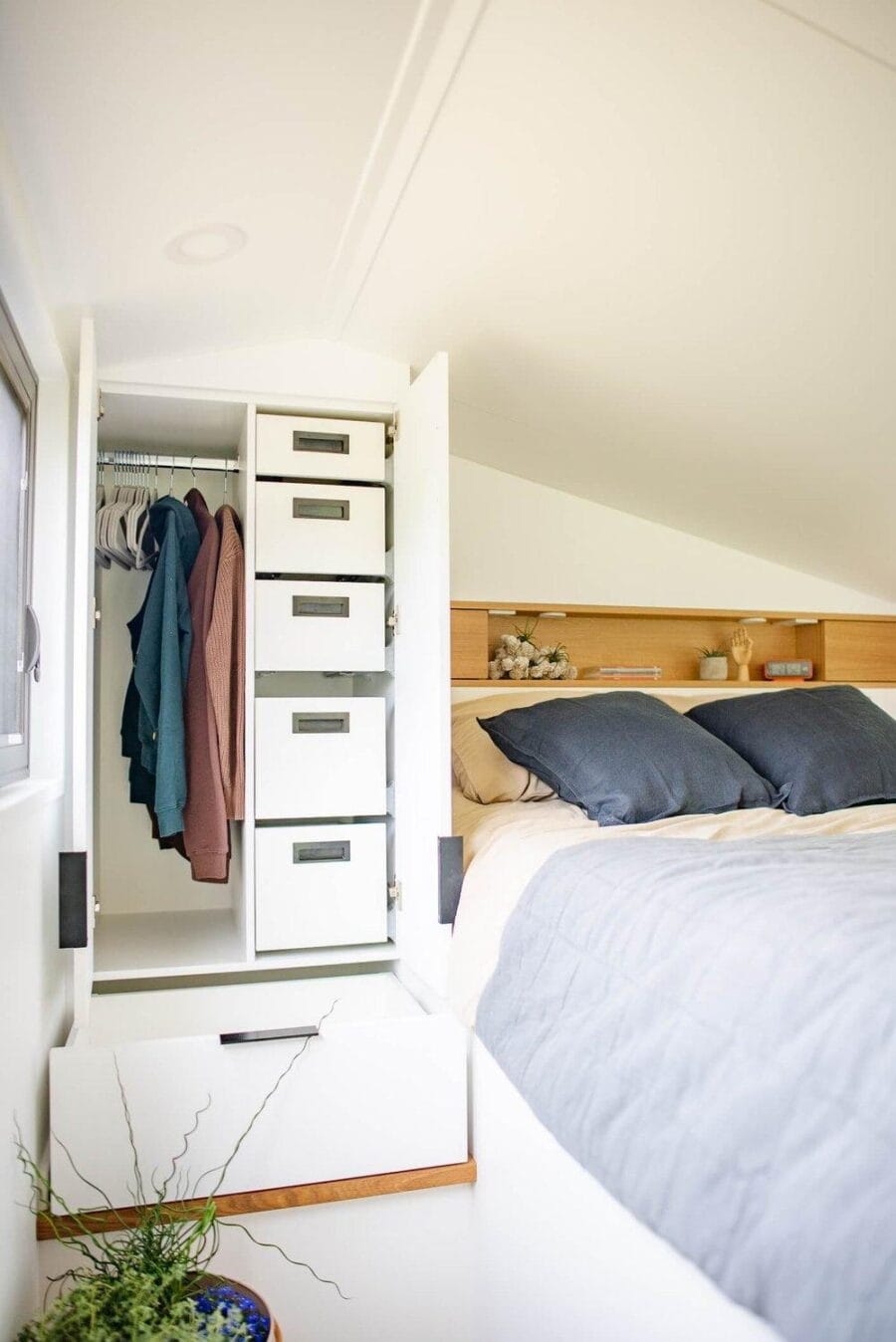 Compact closet with built-in drawers and hanging space in tiny house.