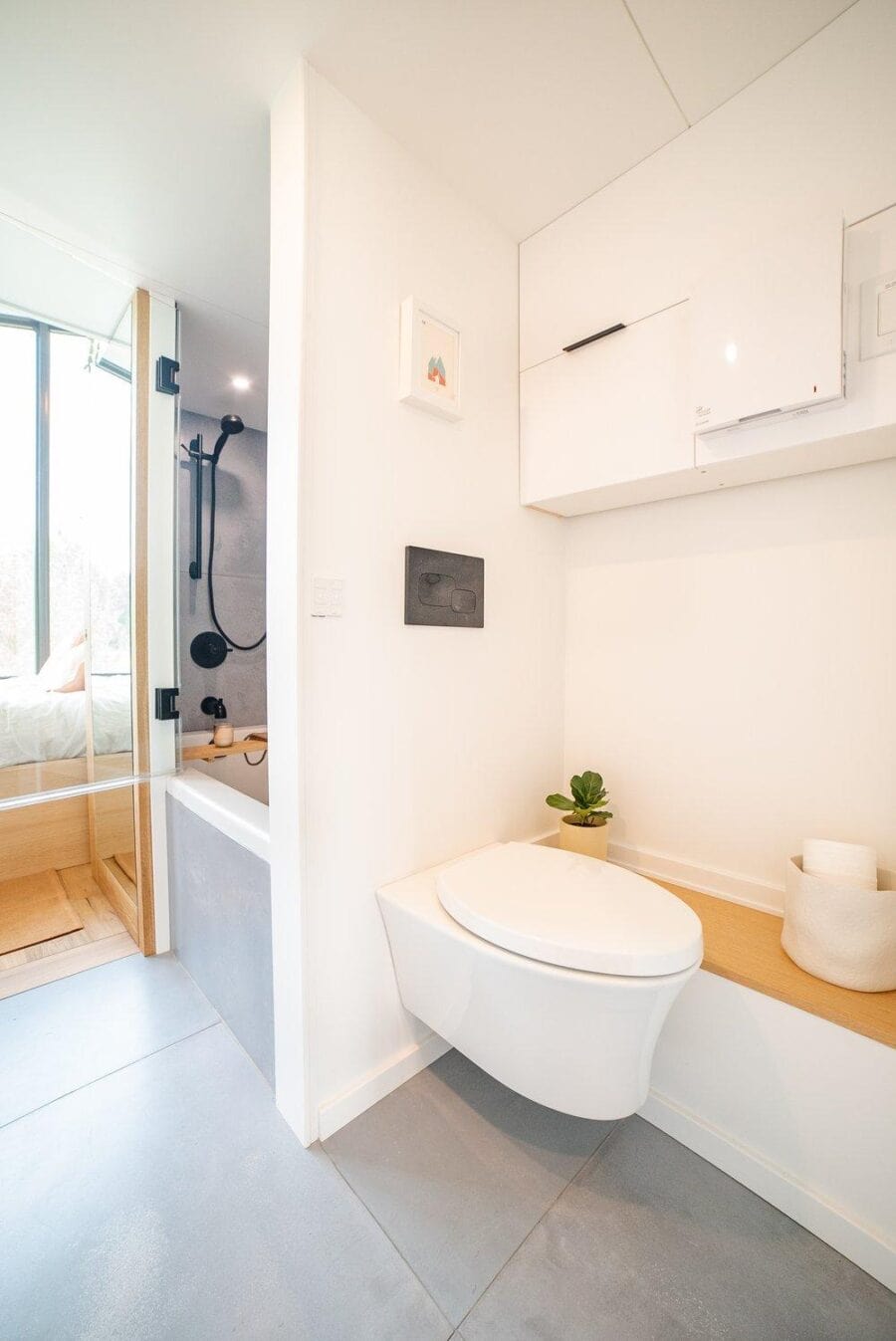 Compact bathroom in a tiny house with modern fixtures and minimalist design.