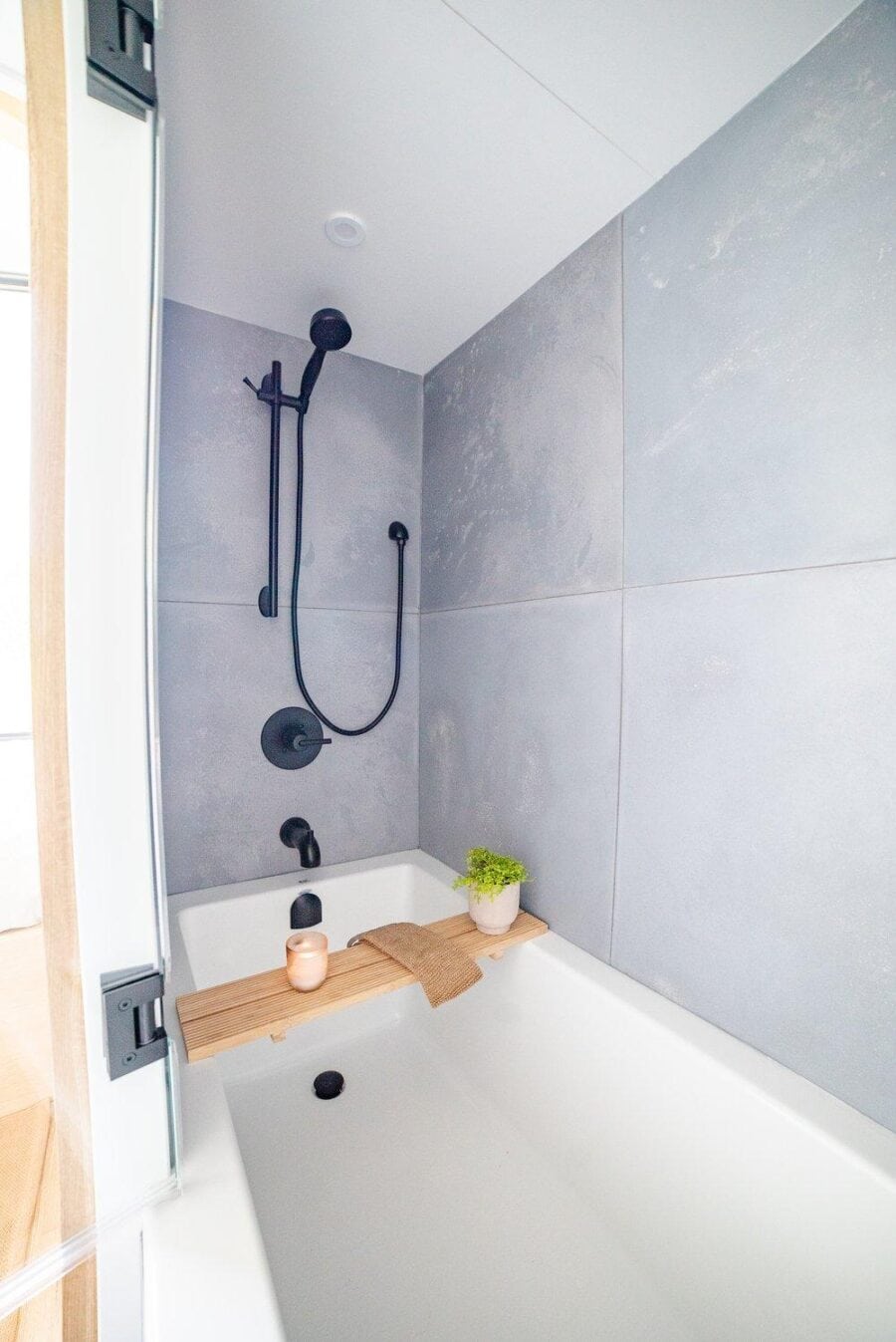 Cozy bathroom in a tiny house with modern gray tiles and minimalist design.