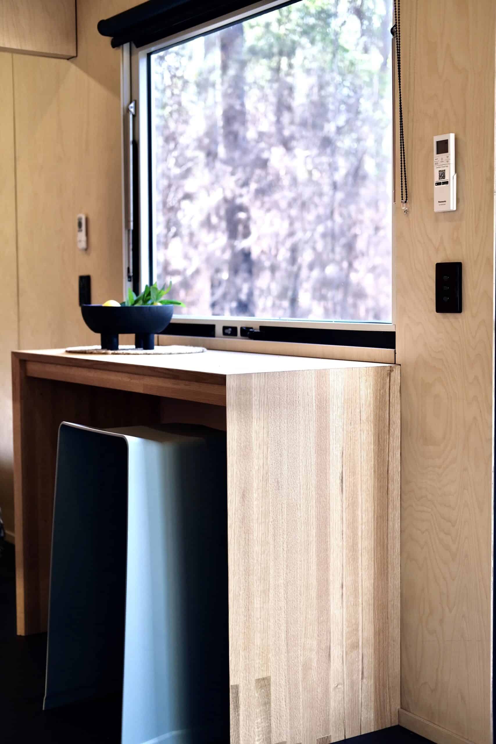 Interior of the Eire tiny house showing whitewashed birch walls and oak flooring