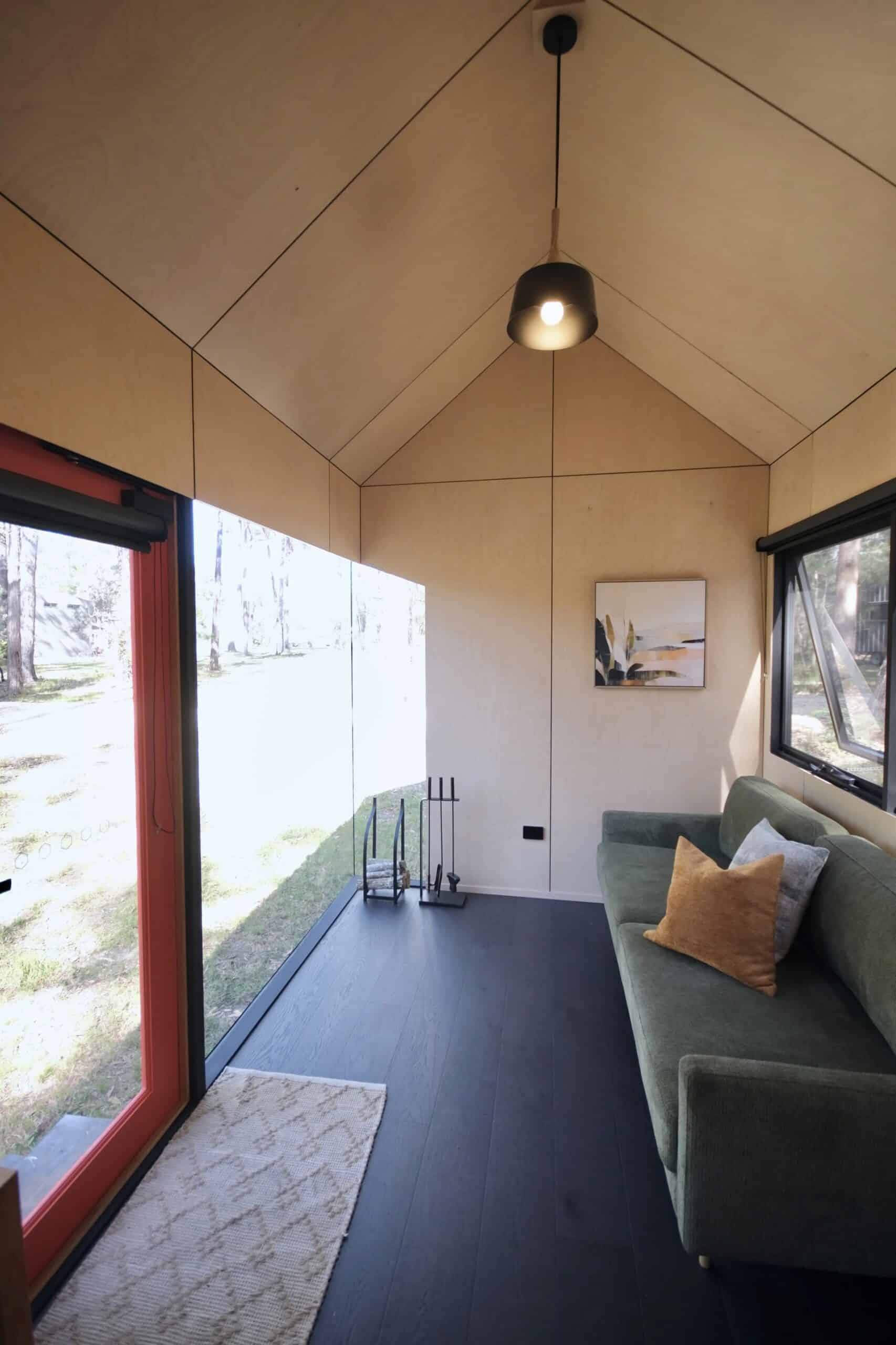 Single-wall kitchen in the Eire tiny house with oak benchtops and black fixtures