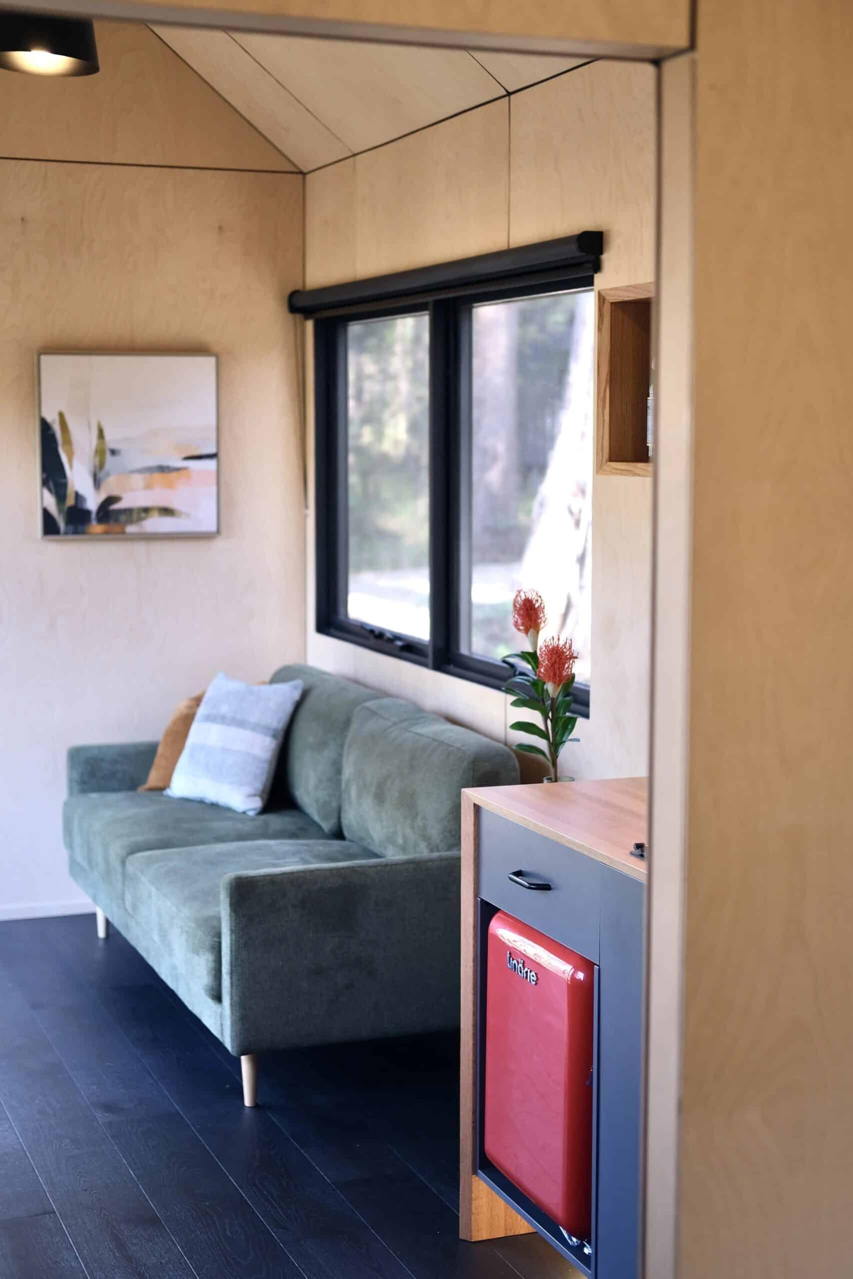 Open living room in the Eire tiny house with large feature window and natural light