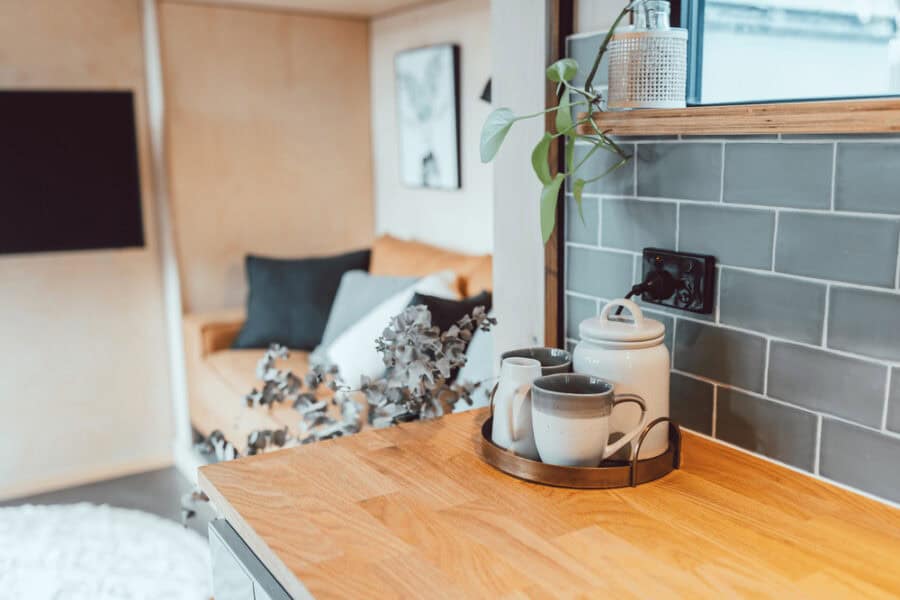 Compact tiny house kitchen featuring sleek design and functional space.