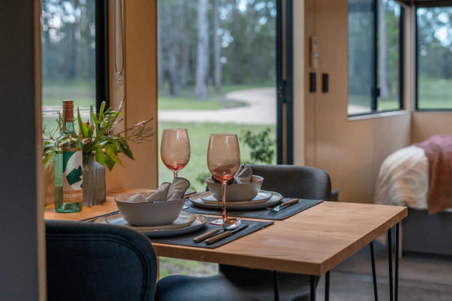 Cozy dining space inside the Luna Tiny House on Wheels in Australia.