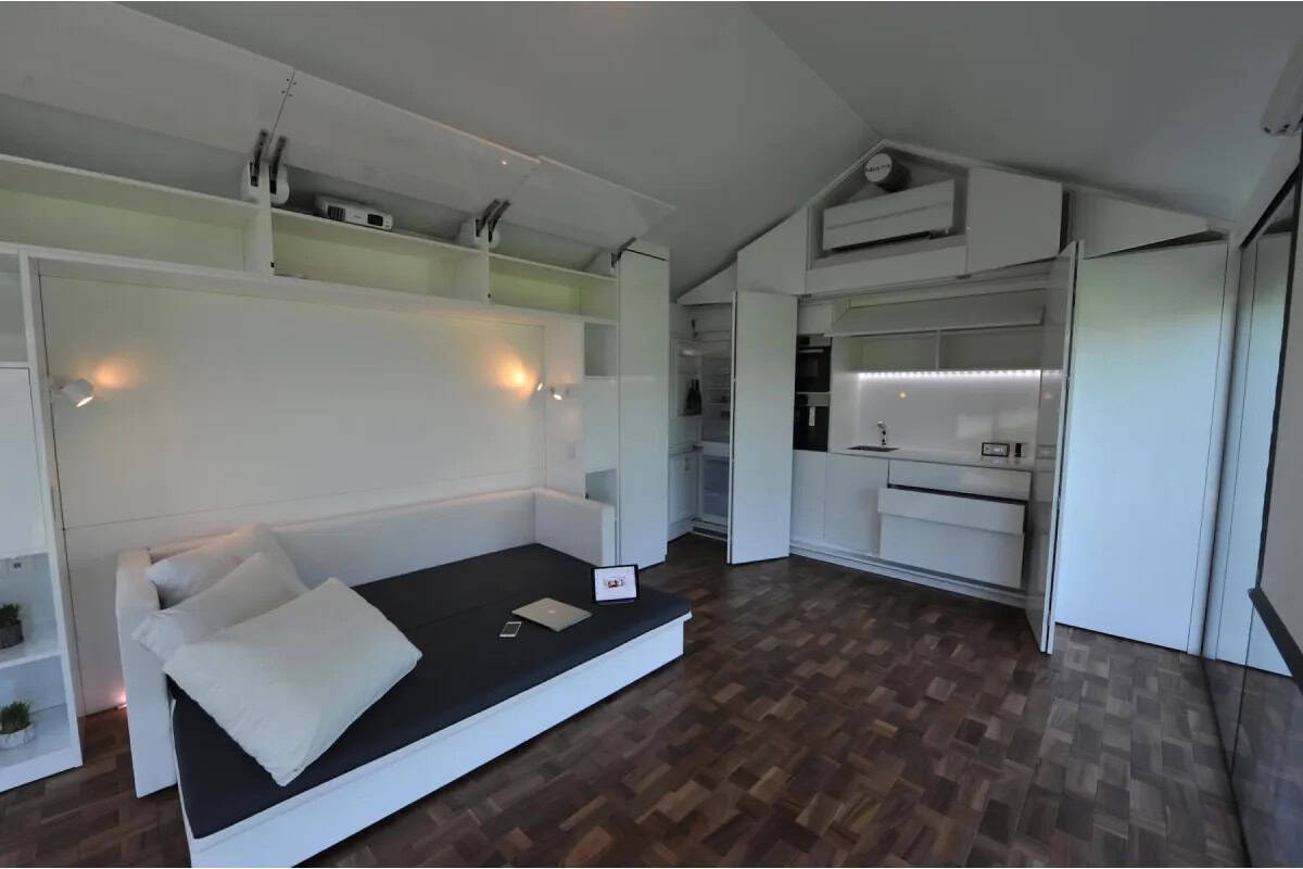 Haus.me mOne wide shot showing full studio layout with bed deployed and kitchen open