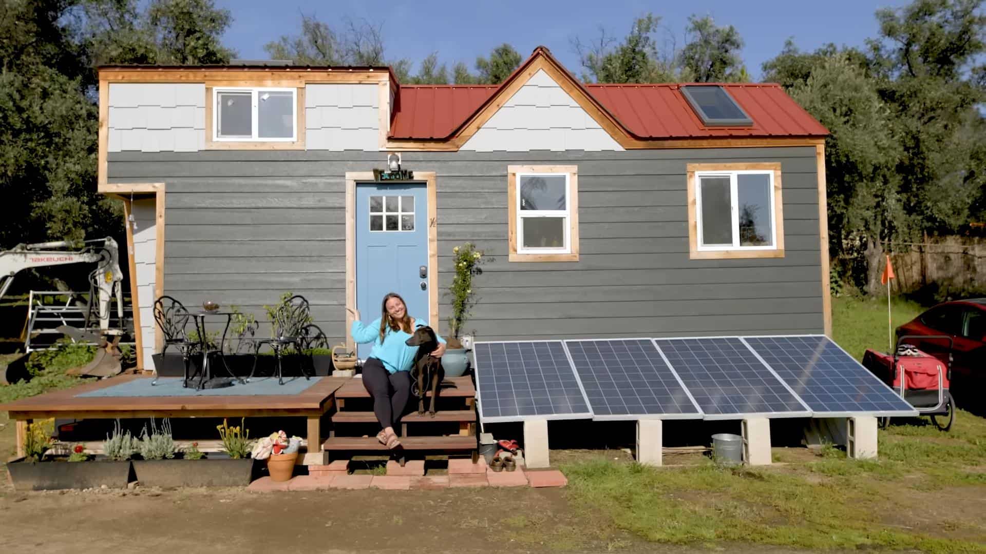 Solar tiny house with blue door and solar panels in Los Angeles.