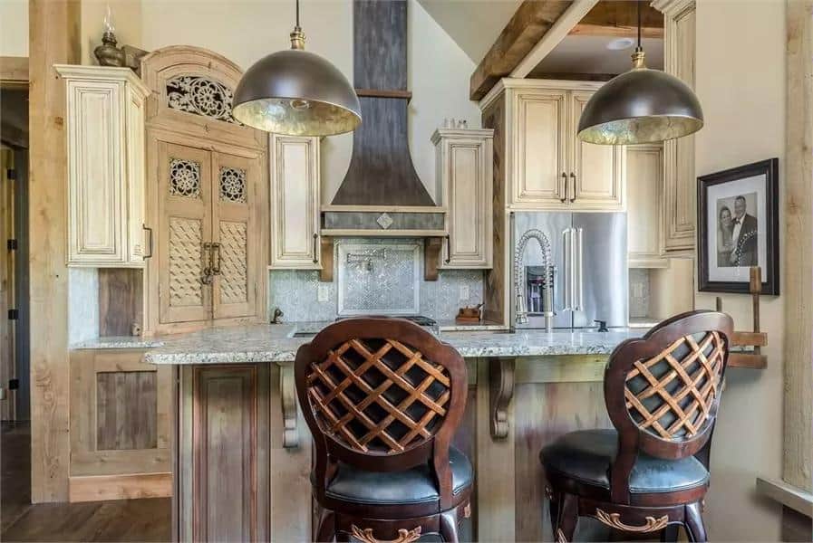 Cozy tiny house kitchen with rustic wood cabinets and modern appliances.