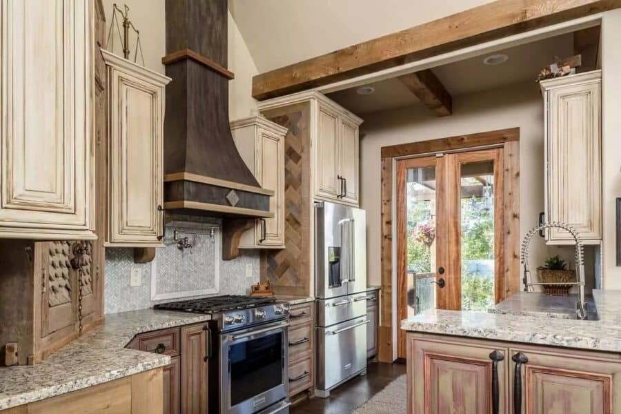Small rustic kitchen with wooden cabinets and modern appliances in a tiny home.