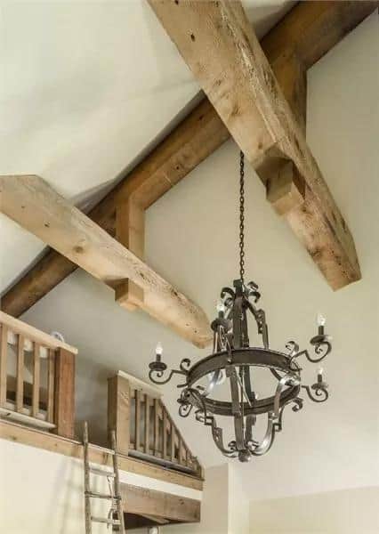 Charming tiny house with exposed wooden beams and a rustic chandelier.