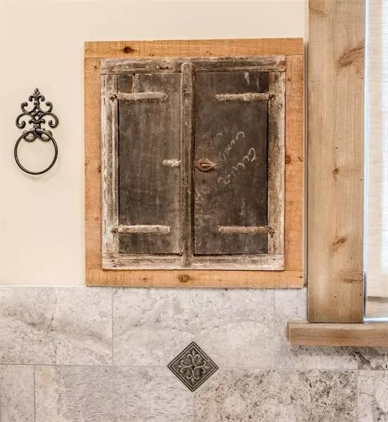 Vintage rustic kitchen cabinet door with weathered wood finish and metal latch.