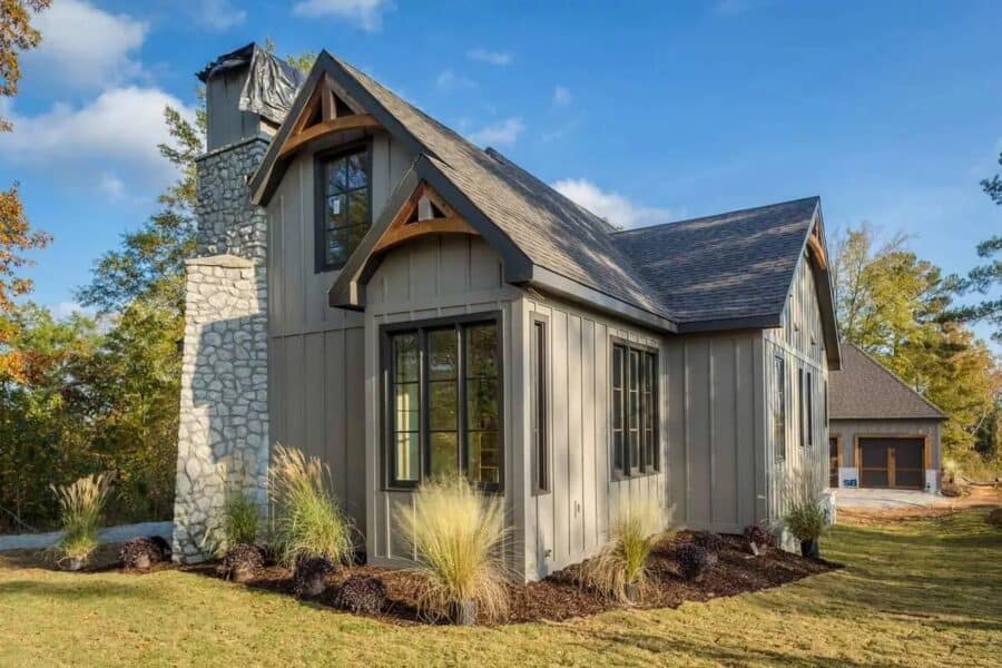 Elegant tiny house with stone chimney and modern design features.
