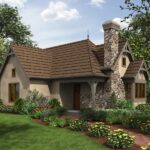 Charming tiny house with stone chimney and lush garden, perfect for small space living.