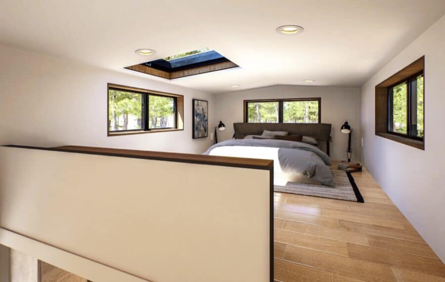 Modern tiny house bedroom with large windows, French doors, and skylight for natural light.