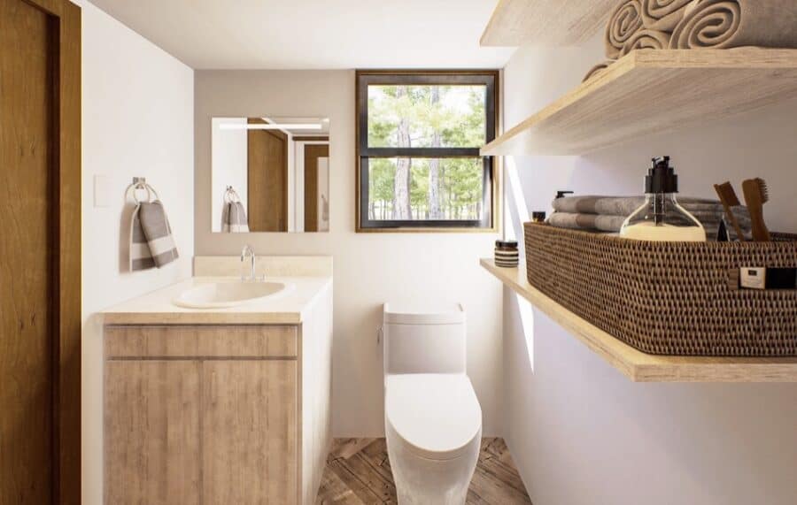 Small bathroom in a tiny house with French doors and minimalist design.