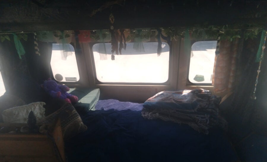 Interior view of a tiny bus converted into a living space inspired by Standing Rock.